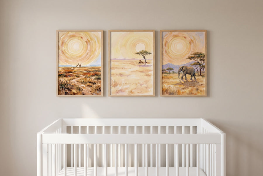 A calm gender-neutral nursery: three golden savanna prints hung as one block over a white convertible crib, filling about two-thirds of the wall with the bottom edge clear of the rail