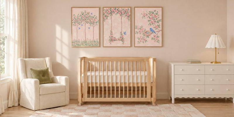 Rose nursery: three framed pink rose prints above a light wood crib, with an ivory glider and a white dresser