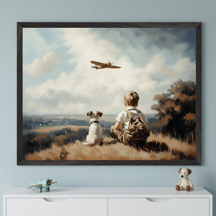 Kid's room with light blue walls. A large dark-framed painting of a boy and dog watching an airplane fly over a landscape hangs centered above a white dresser. A toy plane and stuffed dog are on the dresser.