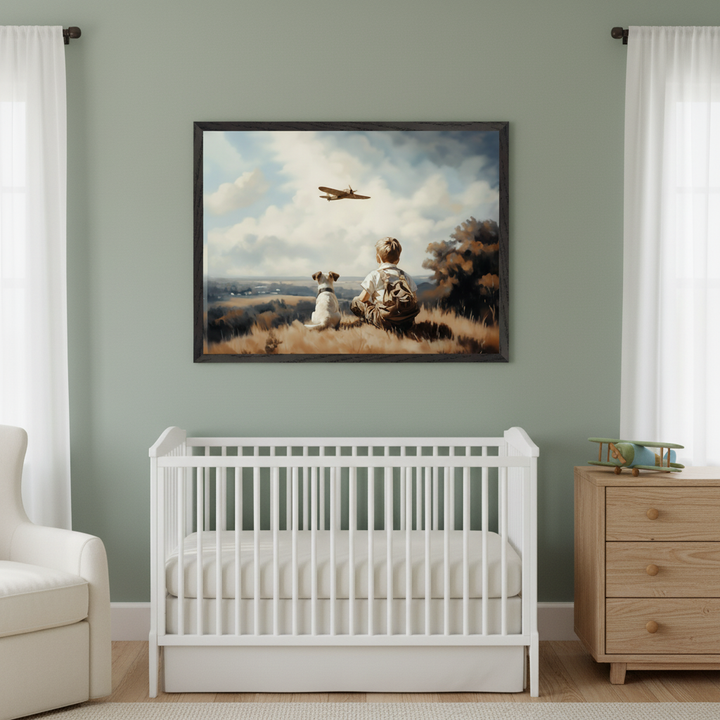 Modern nursery with a white crib, white armchair, and light wood dresser. A large framed print of a boy and a dog on a hill watching an airplane in a painterly style hangs centered above the crib.