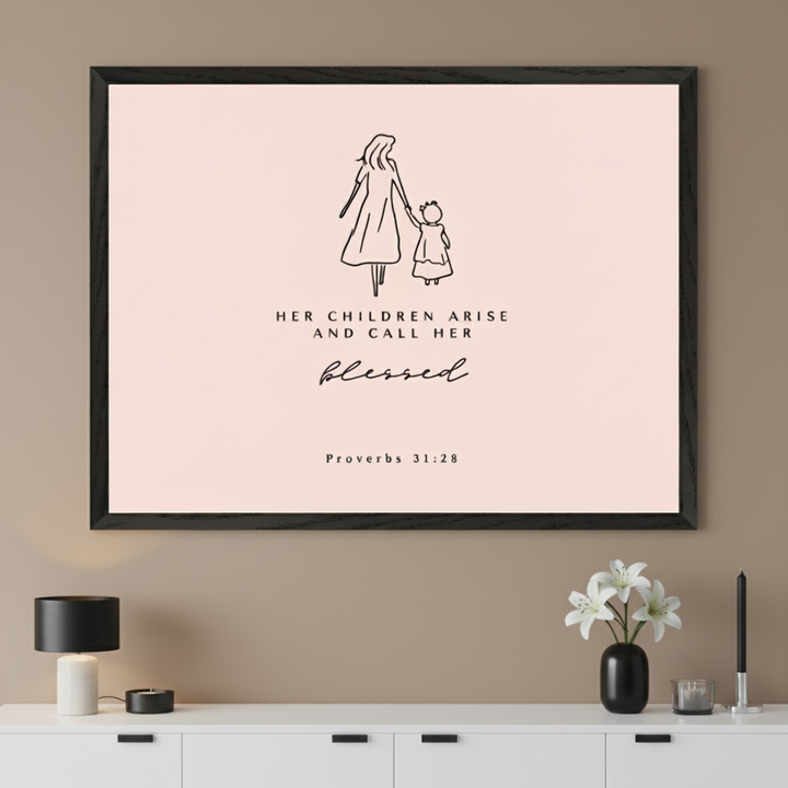 Modern living room with a white sideboard. A large black-framed print hangs centered above the sideboard. The artwork features a minimalist line drawing of a mother and child, with the quote "HER CHILDREN ARISE AND CALL HER blessed Proverbs 31:28" on a light pink background.