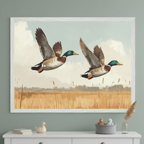 Kid's room with a white dresser against a light green wall. A large white-framed painting of two flying mallard ducks over a reedy landscape hangs above the dresser.