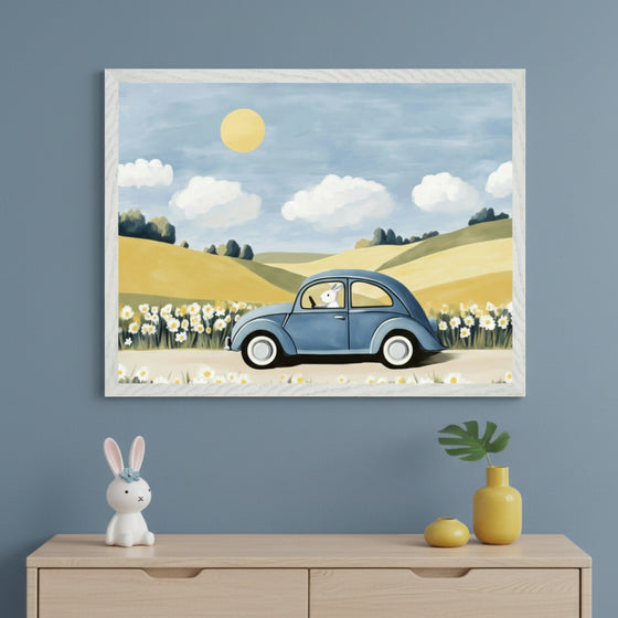 Modern kid's room with a light wood dresser. A large framed painting hangs above the dresser. The painting shows a blue classic car driven by a white rabbit on a road through yellow hills with daisies under a blue sky with a yellow sun.