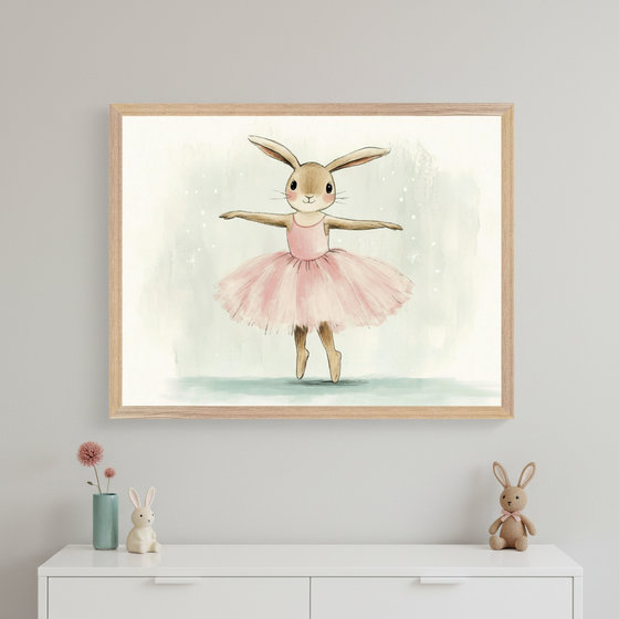Kid's room with a light gray wall and a white dresser. A large framed watercolor print of a ballerina bunny in a pink tutu hangs centered above the dresser. A small teal vase with a flower and two bunny figurines are on the dresser.