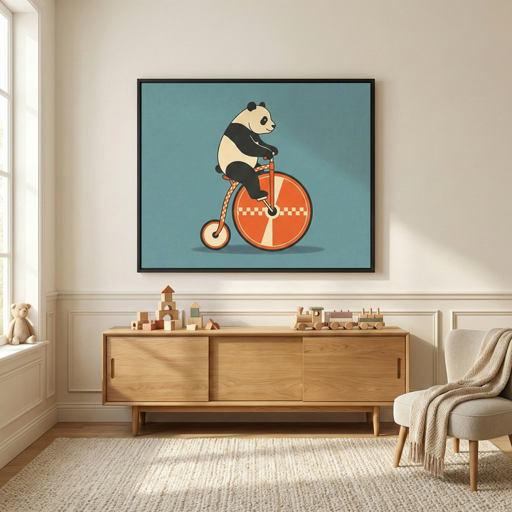 Whimsical retro panda animal on a bicycle wall art hanging above a light wood sideboard in a minimalist nursery playroom.