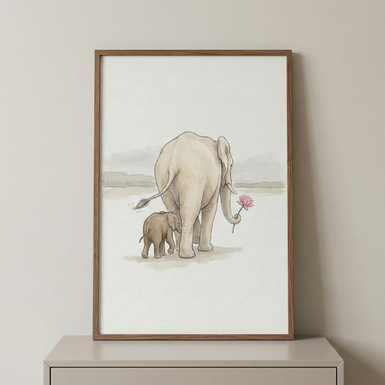 A vertical framed piece displays a minimalist watercolor-style illustration of an adult elephant and its calf walking away. The larger elephant, colored in soft cream, holds a pink flower in its trunk. Beside it, the smaller calf is a darker shade of gray. They travel across a light, hazy landscape. The artwork is set in a thin, natural wood frame and sits on a neutral surface against a plain wall.