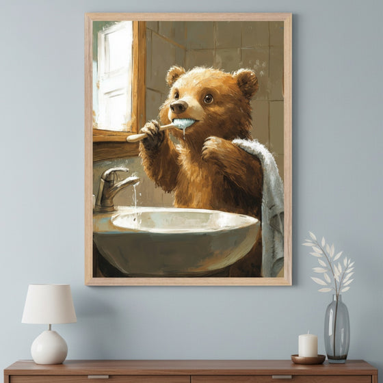 Modern living room with a wooden console table. A framed painting of a brown bear brushing its teeth at a sink in a bathroom, rendered in an illustrative style, hangs centered above the table. A white lamp, a candle, and a vase are on the table.