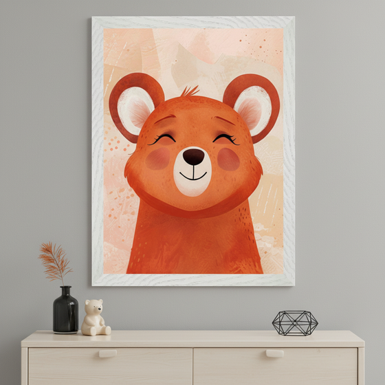 Modern room with a light wood dresser. A large framed illustration of a smiling reddish-brown cartoon bear with closed eyes and pink cheeks hangs centered above the dresser. A black vase, a white bear figurine, and a geometric object are on the dresser.