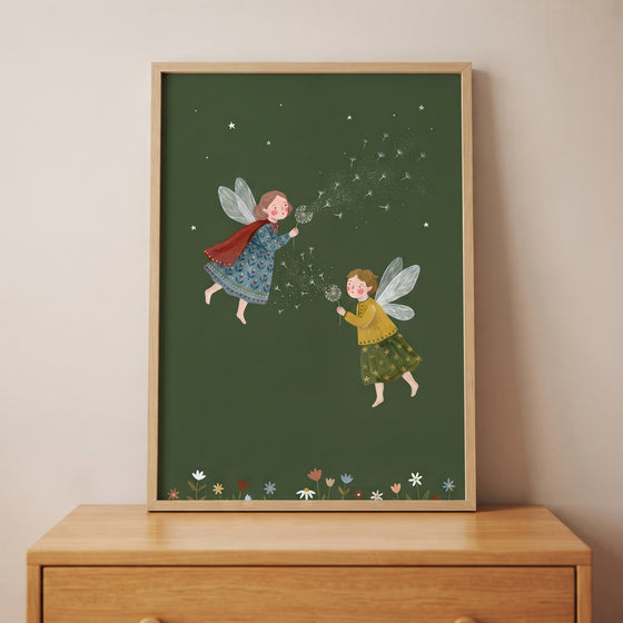 Blowing dandelion seed fairies wall art in a frame shows two winged figures on a green background above a wooden dresser.