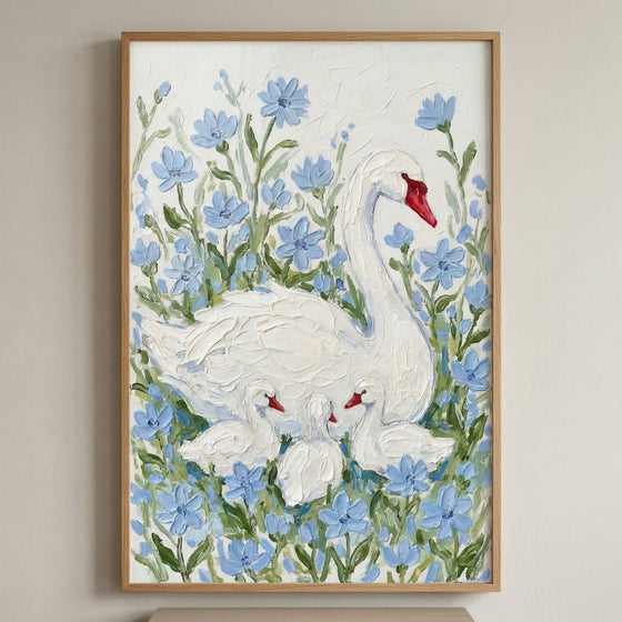 Framed painting of a white swan with three cygnets nestled among soft blue flowers against a textured white background. The swan curves protectively around the babies creating a calm nurturing scene.