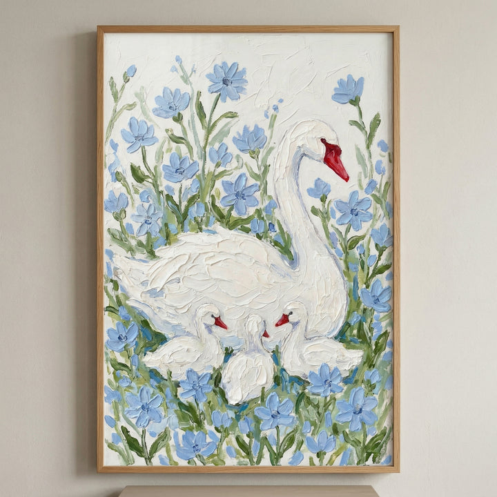 Framed painting of a white swan with three cygnets nestled among soft blue flowers against a textured white background. The swan curves protectively around the babies creating a calm nurturing scene.
