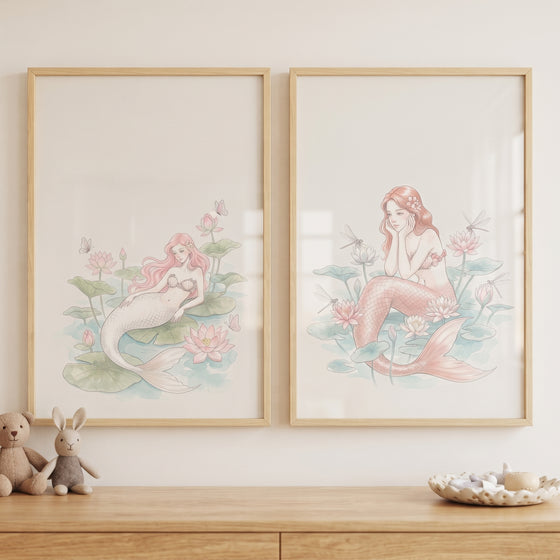 Blush pink watercolor mermaid wall art set of 2 with lotuses hung above a wooden dresser with plush toys.
