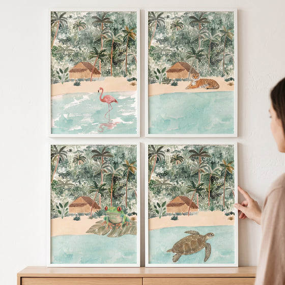 Boho watercolor tropical animals wall art set of 4 featuring a flamingo, tiger, frog, and sea turtle in white frames.