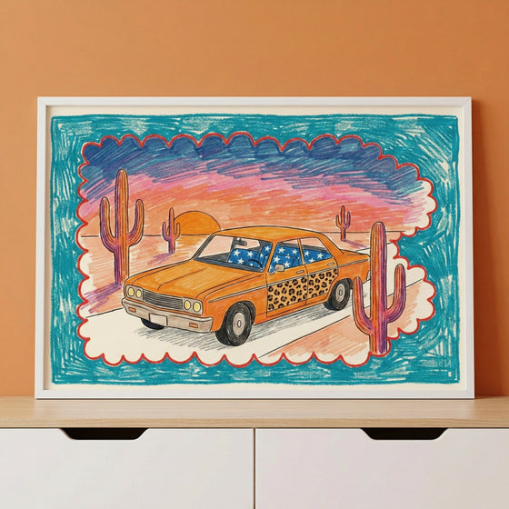 Colorful framed artwork of a stylized orange car with leopard print doors and blue star-patterned windows, parked in a cartoonish desert landscape with cacti and a vivid sunset sky. The scene is surrounded by a bold blue and red scalloped border.