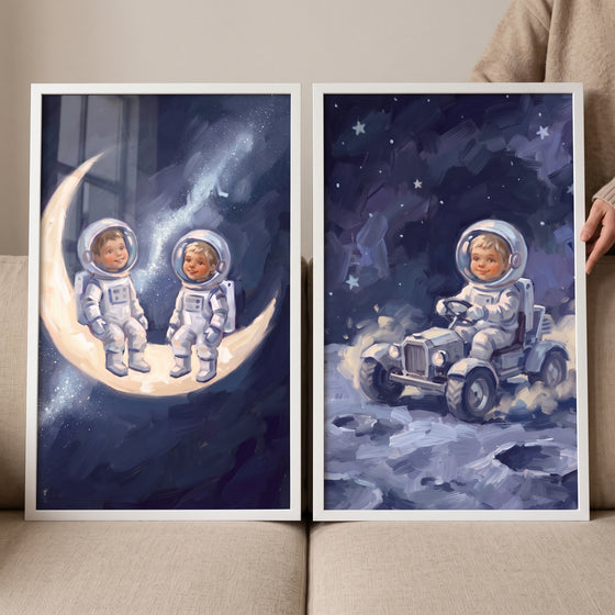 Celestial midnight baby astronaut wall art set of 2 featuring two small explorers on a crescent moon and one in a space.