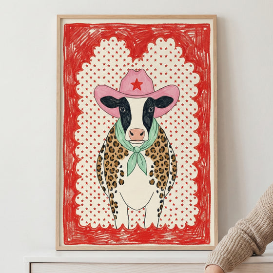 Whimsical illustration of a cow wearing a pink cowboy hat, green scarf, and leopard-print vest, framed with a bold red star-patterned border.