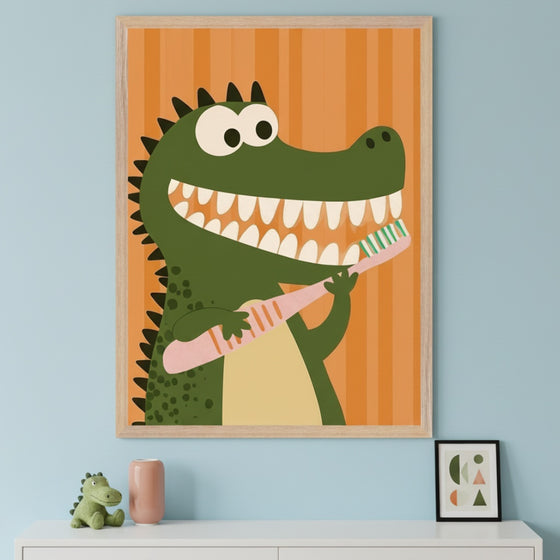 Modern kid's room with a light blue wall and white dresser. A large framed cartoon print of a smiling green alligator holding a pink toothbrush, set against an orange striped background, hangs above the dresser. A plush alligator toy and a pink vase sit on the dresser.