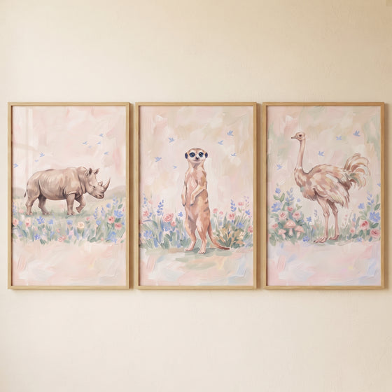 Dainty floral african animals wall art set of 3 with a rhino, meerkat, and ostrich amidst soft pastel flowers.