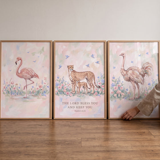 Dainty floral safari animals wall art set of 3 features a flamingo, cheetahs, and an ostrich with a religious blessing.