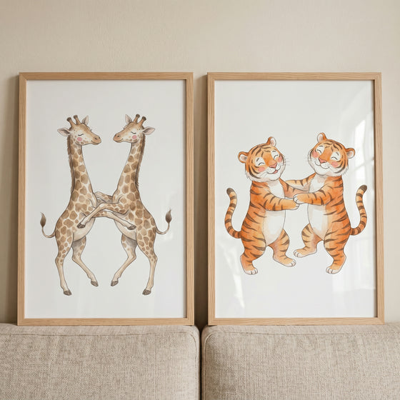 Watercolor dancing safari animals wall art set of 2 featuring two giraffes and two tigers in light wood frames.