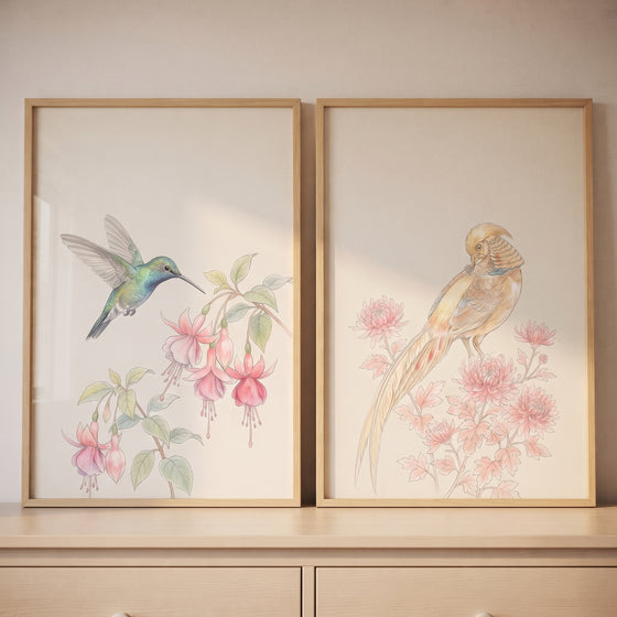 Delicate pink floral bird wall art set of 2 featuring watercolor hummingbird and pheasant prints in wood frames.