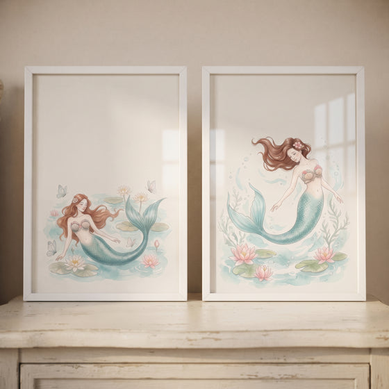 Delicate teal tail mermaid wall art set of 2 features ethereal mermaids swimming among soft pink lilies in white frames.