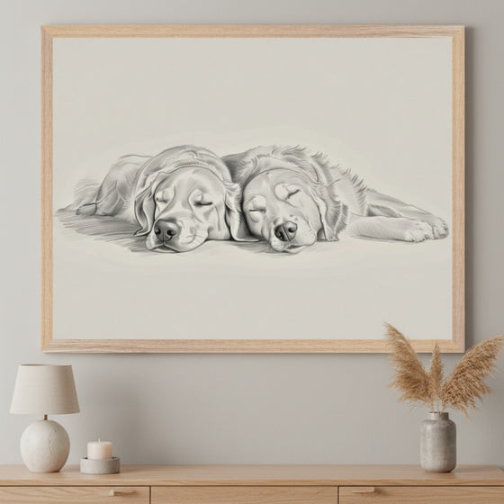 Modern living room with a light wood console table. A large framed pencil drawing of two sleeping golden retrievers hangs centered above the table. A lamp and dried grass vase are on the table.