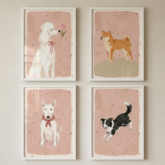 Four framed illustrations of dogs are displayed in a two-by-two grid on a wall. Each image features a different breed against a soft pink background with tiny stars. Top left: a white poodle with a red bow looking at a flower. Top right: a tan and white dog standing on a small hill.