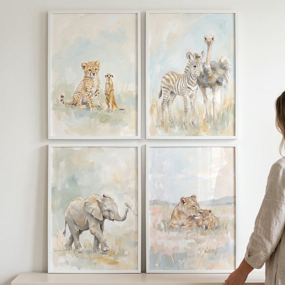 Earthy watercolor safari animals print set of 4 with a cheetah, meerkat, zebra, ostrich, elephant, and lions in white frames.