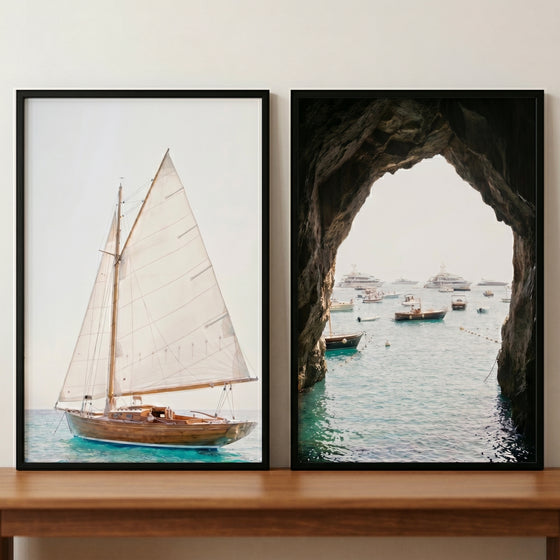 European summer mediterranean boat wall art set of 2 with a wooden sailboat and a view from a sea cave.
