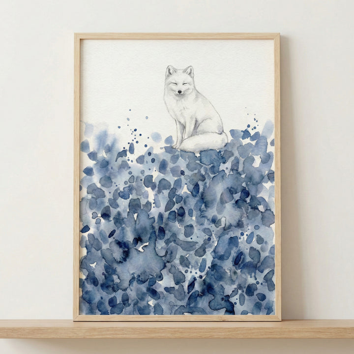 Framed watercolor painting of a white fox sitting calmly atop abstract blue brushstrokes, hung above a wooden crib in a softly lit nursery. The peaceful animal artwork adds a dreamy, serene touch to the baby’s room.