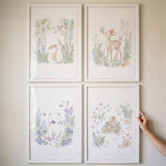 Gender neutral nursery animal artwork set of 4 featuring watercolor bunny, deer, bear, and turtle illustrations in white.
