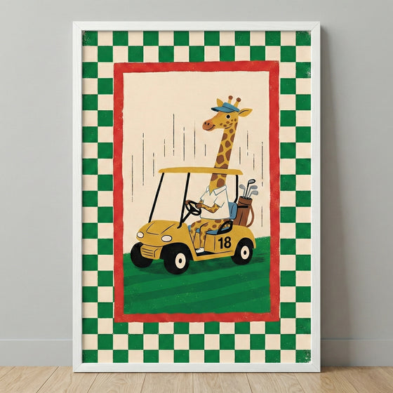 A framed whimsical illustration featuring a cartoon giraffe driving a yellow golf cart across a green field. The giraffe wears a blue visor and a white collared shirt. The golf cart has the number "18" printed on its side and carries a brown bag filled with clubs in the back. The central scene is enclosed by a red border, which is further surrounded by a green and cream checkered pattern. The entire piece is held in a plain white frame against a neutral-toned wall.