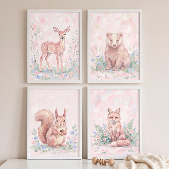 Grandmillennial pink woodland animals wall art set of 4 features a deer, badger, squirrel, and fox among soft flowers.