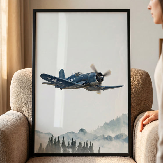 Framed gull wing blue airplane wall art shows a blue vintage aircraft flying over misty mountains and a pine forest.