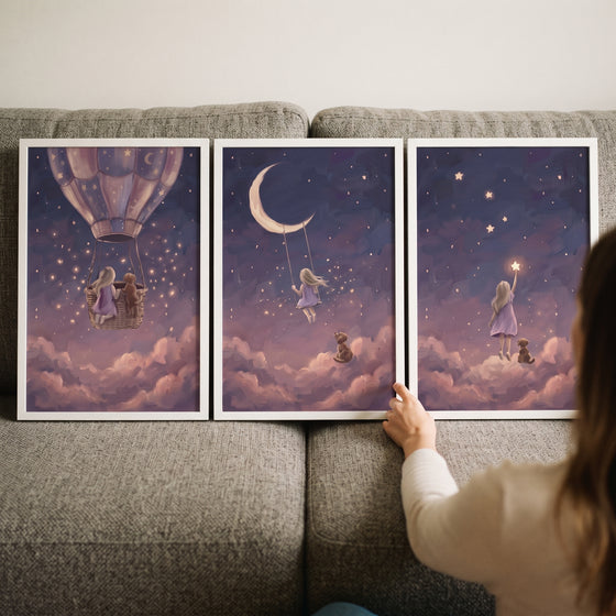 Heather starry girl dog wall art set of 3 shows a girl and dog in a balloon, on a moon swing, and reaching for a star.