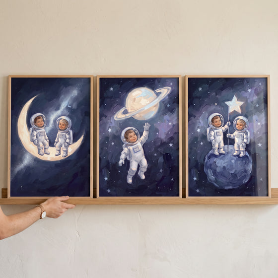 Impressionist starry baby astronaut wall art set of 3 depicts infants in space suits on the moon and planets.