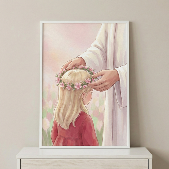 A framed soft-toned illustration depicts Jesus gently placing a pink floral crown on a young girl's head. The girl has long blonde hair and wears a simple red dress. Jesus is shown from the torso down, draped in a white robe. The background is a dreamy, hazy garden with hints of pink and green flowers in a watercolor style. This serene art piece is displayed on a white dresser against a neutral wall, creating a peaceful and spiritual atmosphere.