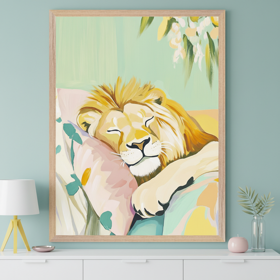 Modern room with a white dresser. A large, light wood-framed painting of a sleeping lion on a pink pillow with abstract floral patterns hangs centered above the dresser. A white lamp, pink dish, pink candle, and vase with leaves are on the dresser.
