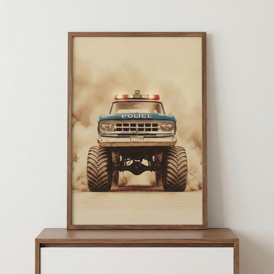 A vertical wood-framed print of a vintage blue monster truck styled as an emergency vehicle. The truck features massive, deeply treaded tires, a high-clearance suspension, and flashing light bars on the roof. The word "POLICE" is printed across the front hood. The image is captured from a low-angle front perspective as the vehicle drives through a thick cloud of dust, creating a dramatic and powerful scene. The artwork has a muted, sepia-toned aesthetic, giving it an aged look. The frame is placed on a smoo