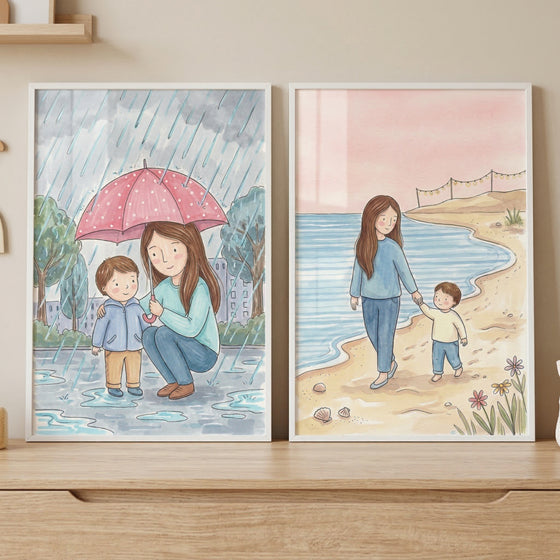 Two framed vertical illustrations sit side-by-side on a light wooden surface. The artwork features a soft, gentle style with a muted color palette.
The illustration on the left depicts a scene on a rainy day. A woman with long brown hair is crouching down, holding a large pink umbrella with white polka dots over herself and a young boy. The boy, wearing a light blue jacket and tan pants, stands next to her.