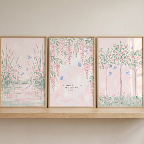 Muted blush botanical garden wall art set of 3 with dragonflies, butterflies, birds, and scripture on a shelf.