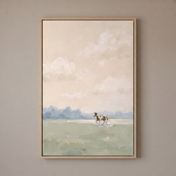 Muted blush pinto horse wall art featuring a brown and white horse in a light green field under a soft cloudy sky.`