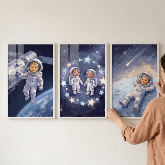 Navy suit baby astronaut wall art set of 3 features infants in space gear exploring the stars and planets.