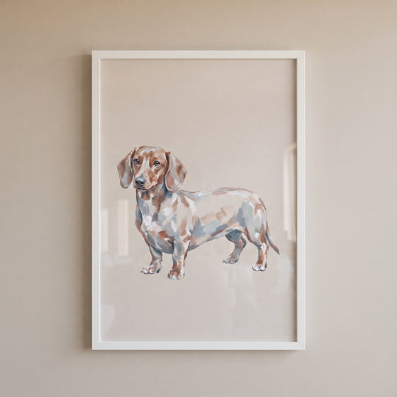 Neutral dapple dachshund wall art in a white frame on a plain beige wall.