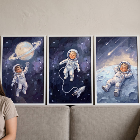 Painterly cosmic baby astronaut wall art set of 3 displays a child exploring space, floating, and resting on a moon.