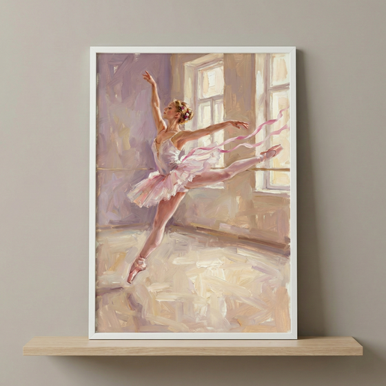 A ballerina is captured in a graceful leap within a soft, impressionistic artwork. She wears a layered pink tutu and matching pointe shoes, with ethereal pink ribbons swirling around her to emphasize motion. The setting is a sunlit studio, where light from large windows creates a luminous atmosphere. Bold, textured strokes and a palette of rose, lavender, and cream define the composition. The piece is housed in a white frame, resting on a wood shelf against a neutral gray wall.