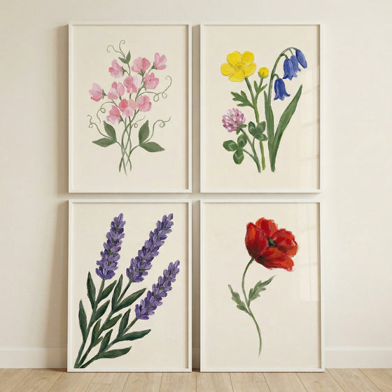 Four framed botanical prints arranged in a grid featuring pink sweet pea flowers colorful wildflowers purple lavender and a single red poppy each painted in a soft hand painted style on a light background.