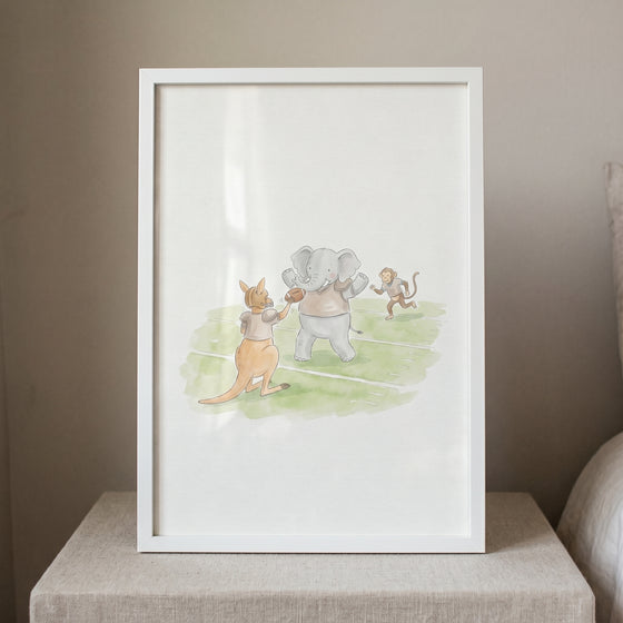 Framed playing football animals print of a kangaroo, elephant, and monkey on a green field.