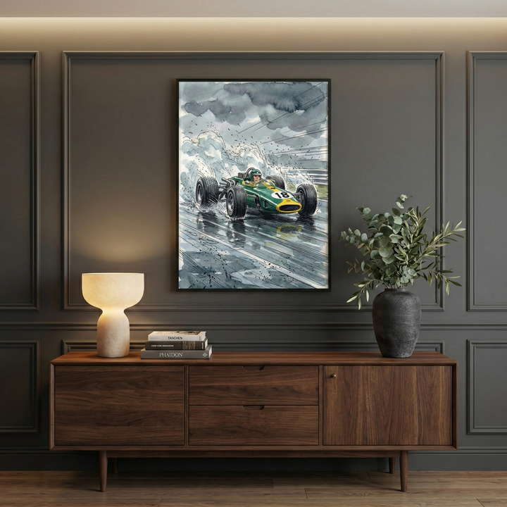 A stylish room features a framed painting of a vintage green race car with the number 18, speeding through rain-soaked streets under cloudy skies. The painting is displayed above a wooden sideboard, which holds a modern lamp, books, and a vase with leafy branches.